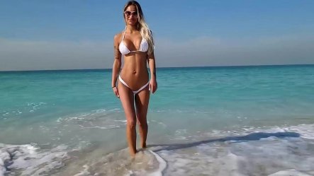 Monika Fox Posing In White Bikini on Beach small screenshot
